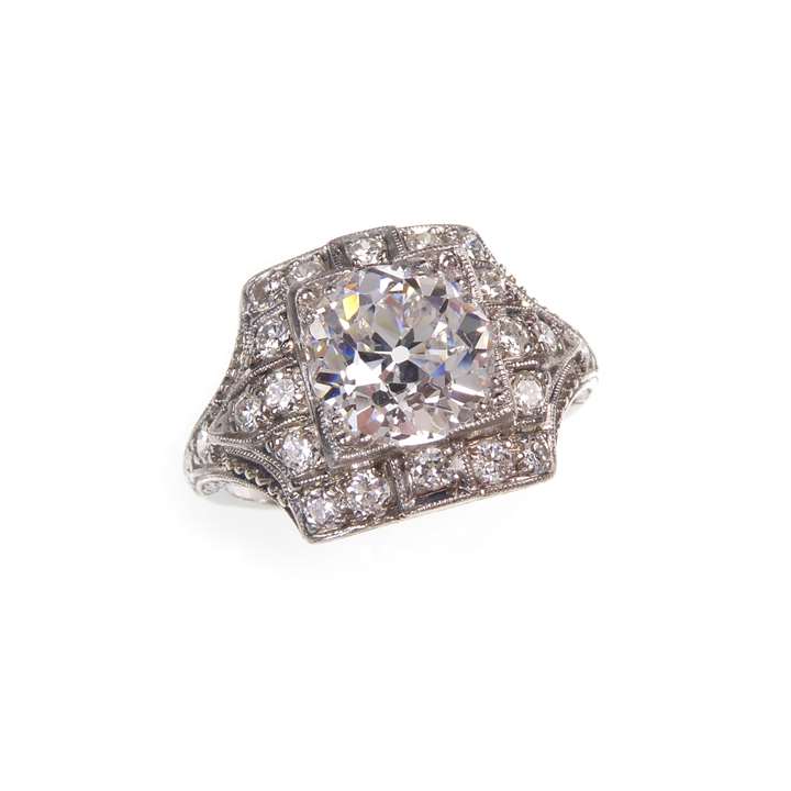 Early Art Deco round brilliant cut diamond and square panel cluster ring, c.1920, set with an old European cut diamond